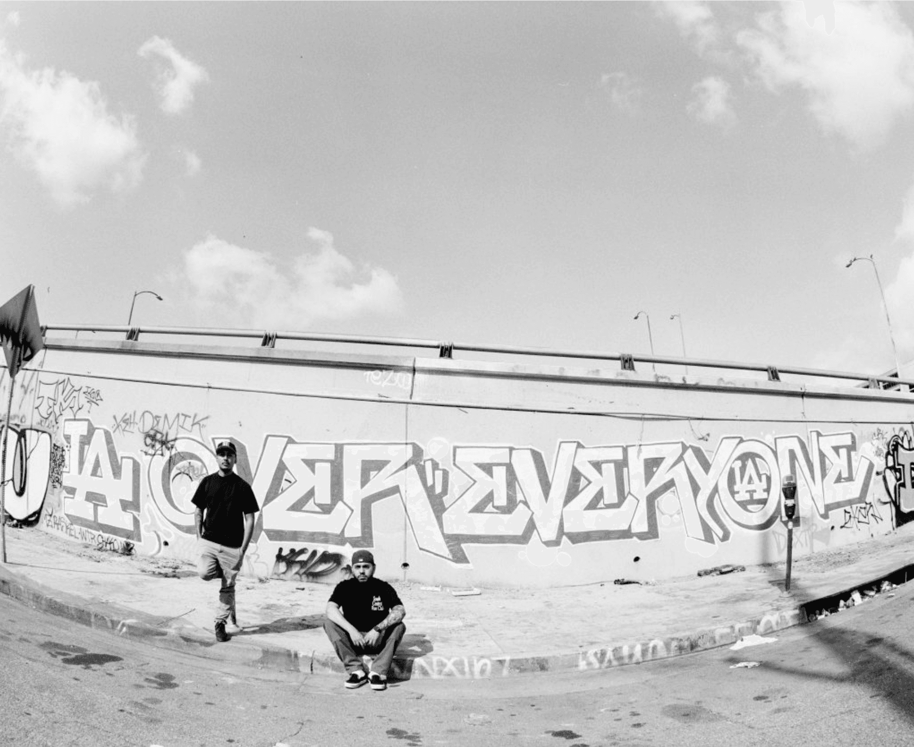 SCLA Clips founders in front of LA Over Everyone graffiti